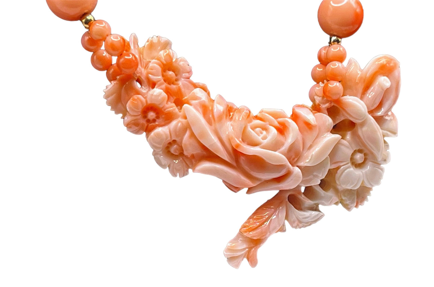 A coral necklace with coral beads and a carved coral pendant