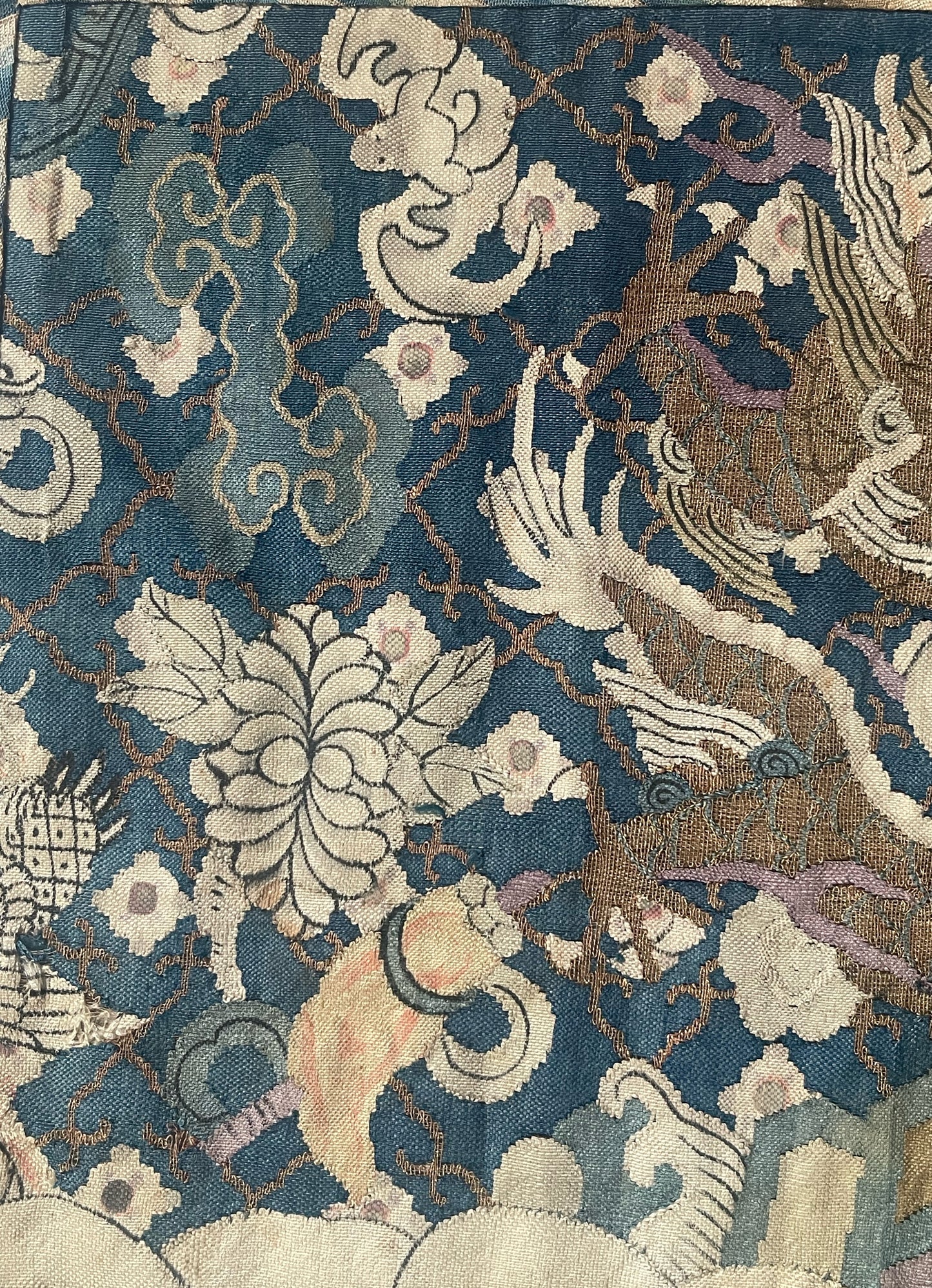 An antique framed Chinese silk kesi of a pair of dragons