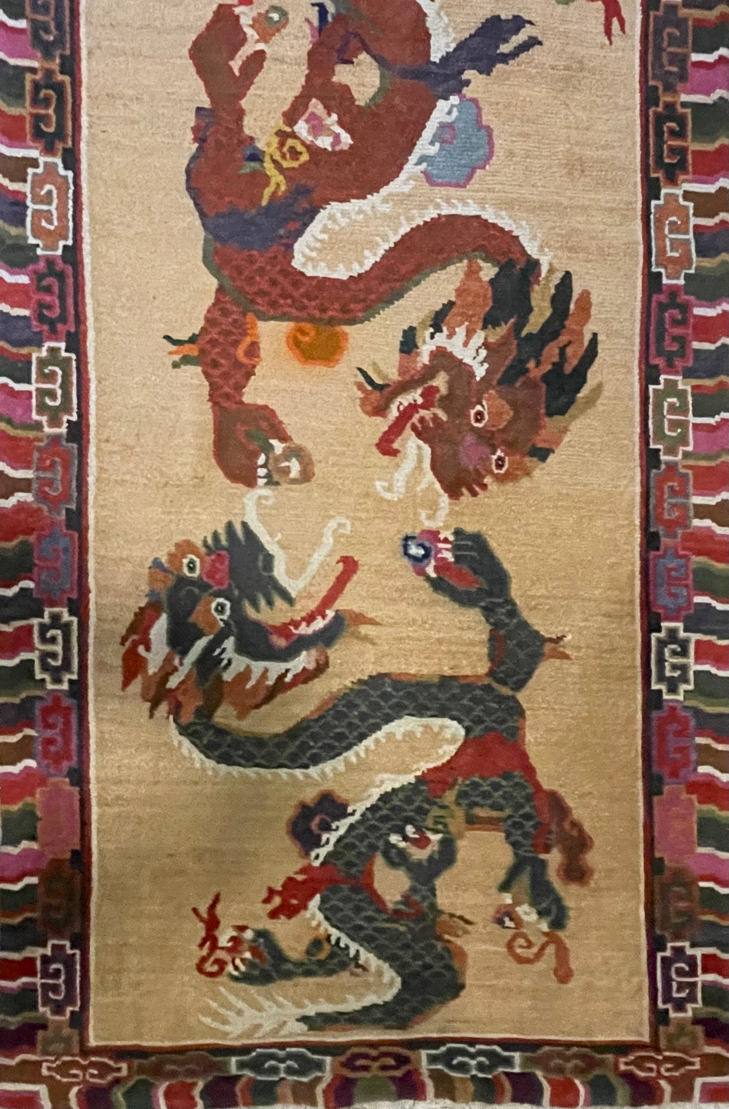 A vintage mid 20th c. Tibetan rug with dragons