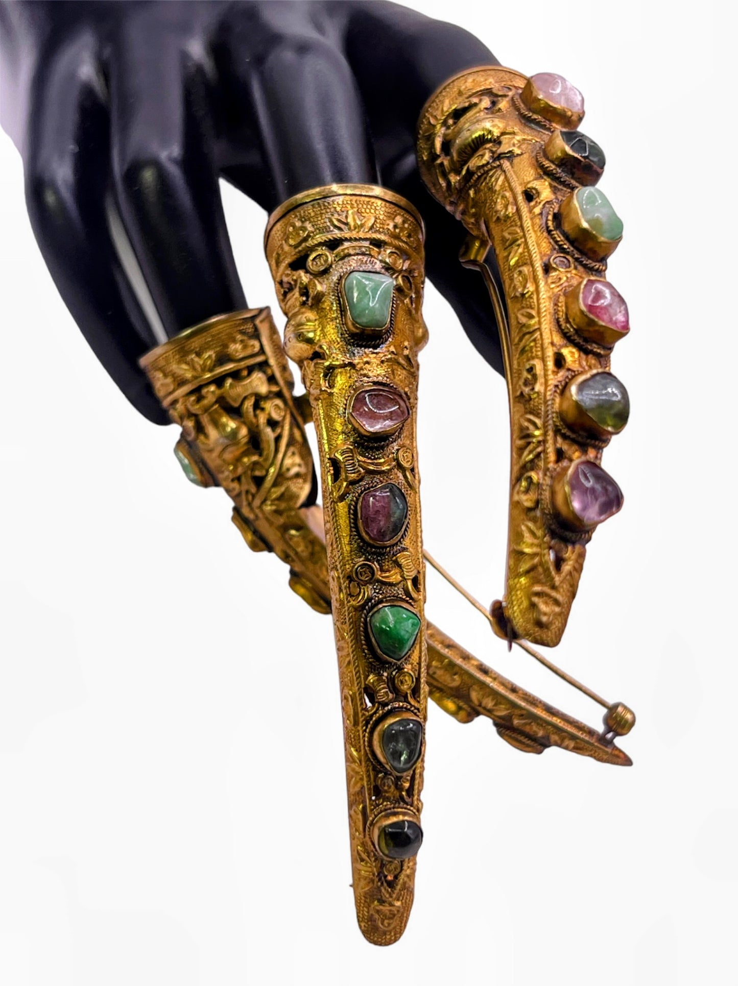 A set of three vintage gilded silver nail covers