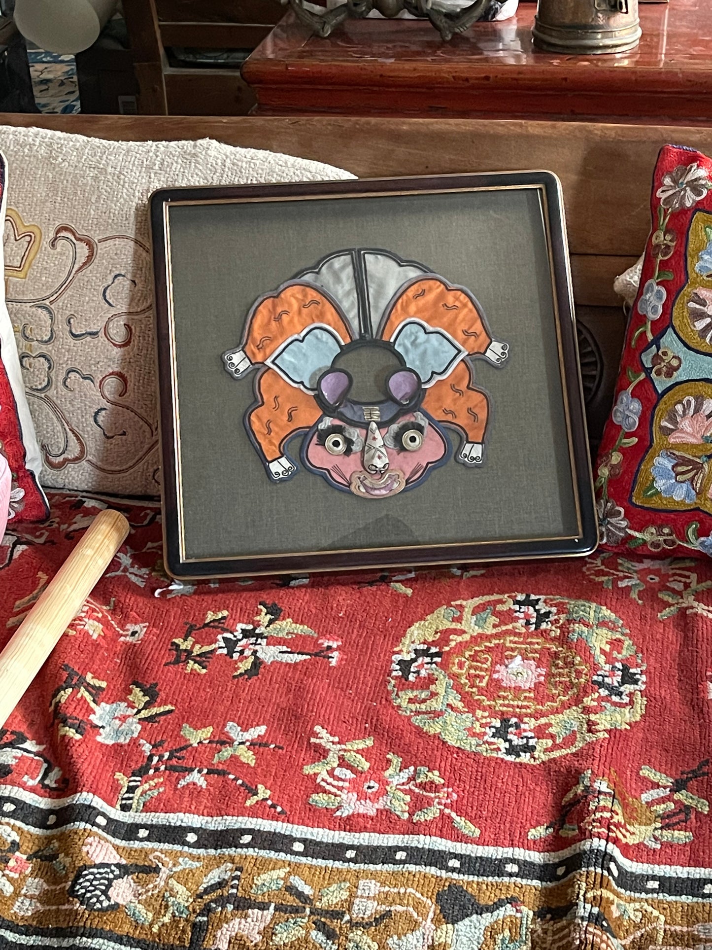 An antique childrens collar with an animal design in a box frame