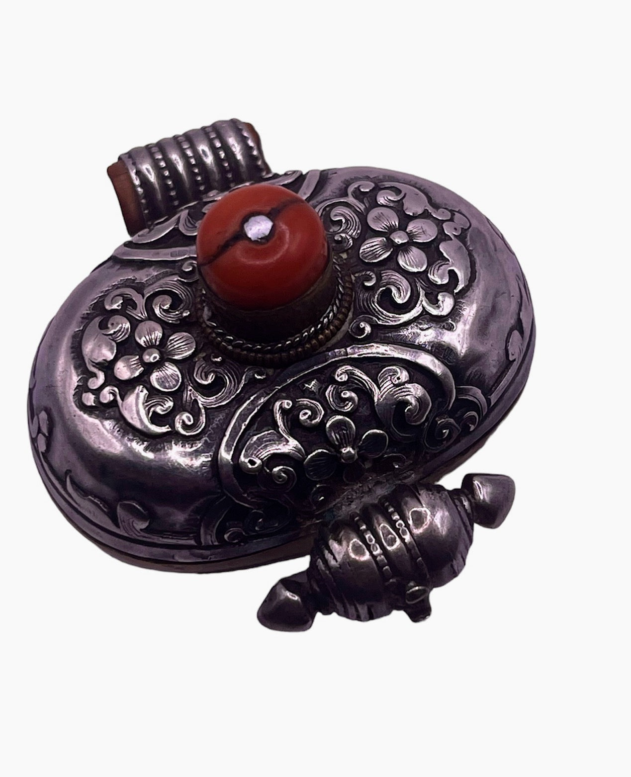 An antique silver and coral ghau amulet