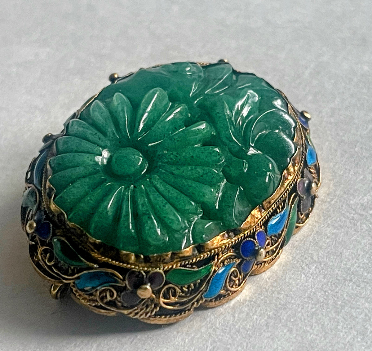 A vintage jade brooch in enameled gilt silver