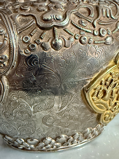 An antique silver and gilt ceremonial Tibetan teapot