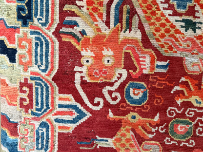 An early 20th C., antique Tibetan dragon rug