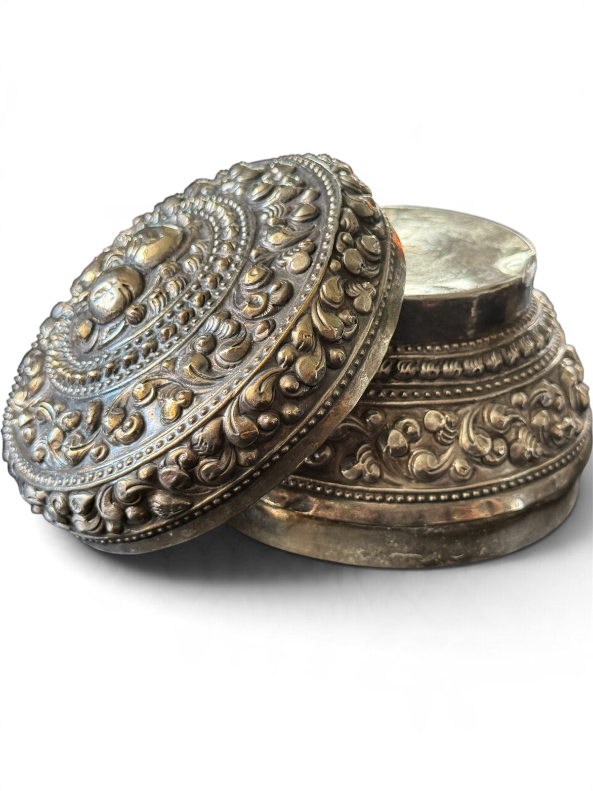 An antique silver south East Asian round box with lid