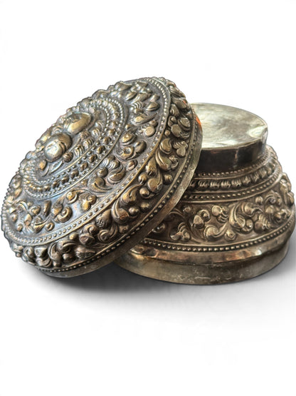 An antique silver south East Asian round box with lid