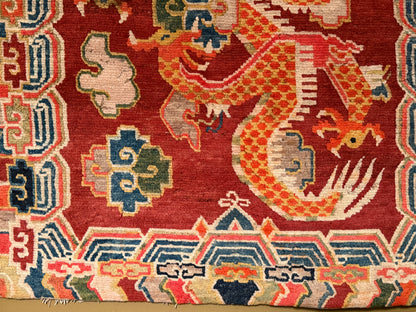 An early 20th C., antique Tibetan dragon rug