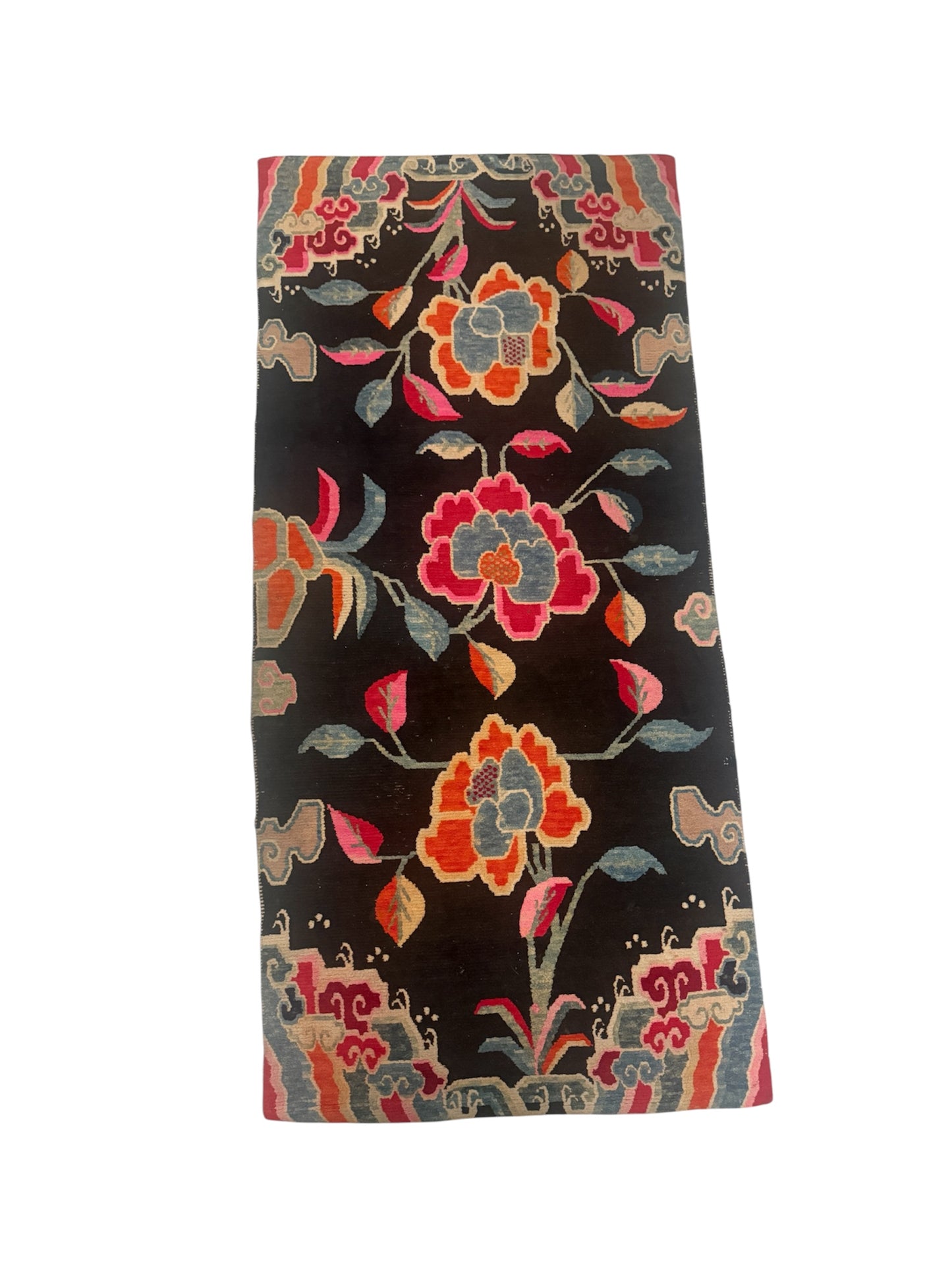 An early 20th C., antique black Tibetan with floral motif rug