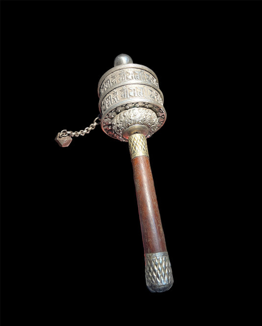 An antique Tibetan handheld prayer wheel