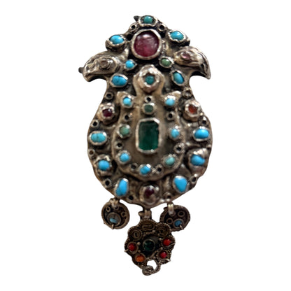 A silver antique turban brooch with turquoise, ruby and emeralds