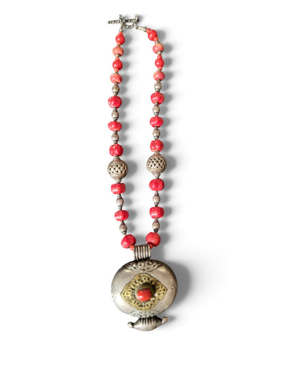 Antique Tibetan coral ghau pendant with a coral and silver necklace
