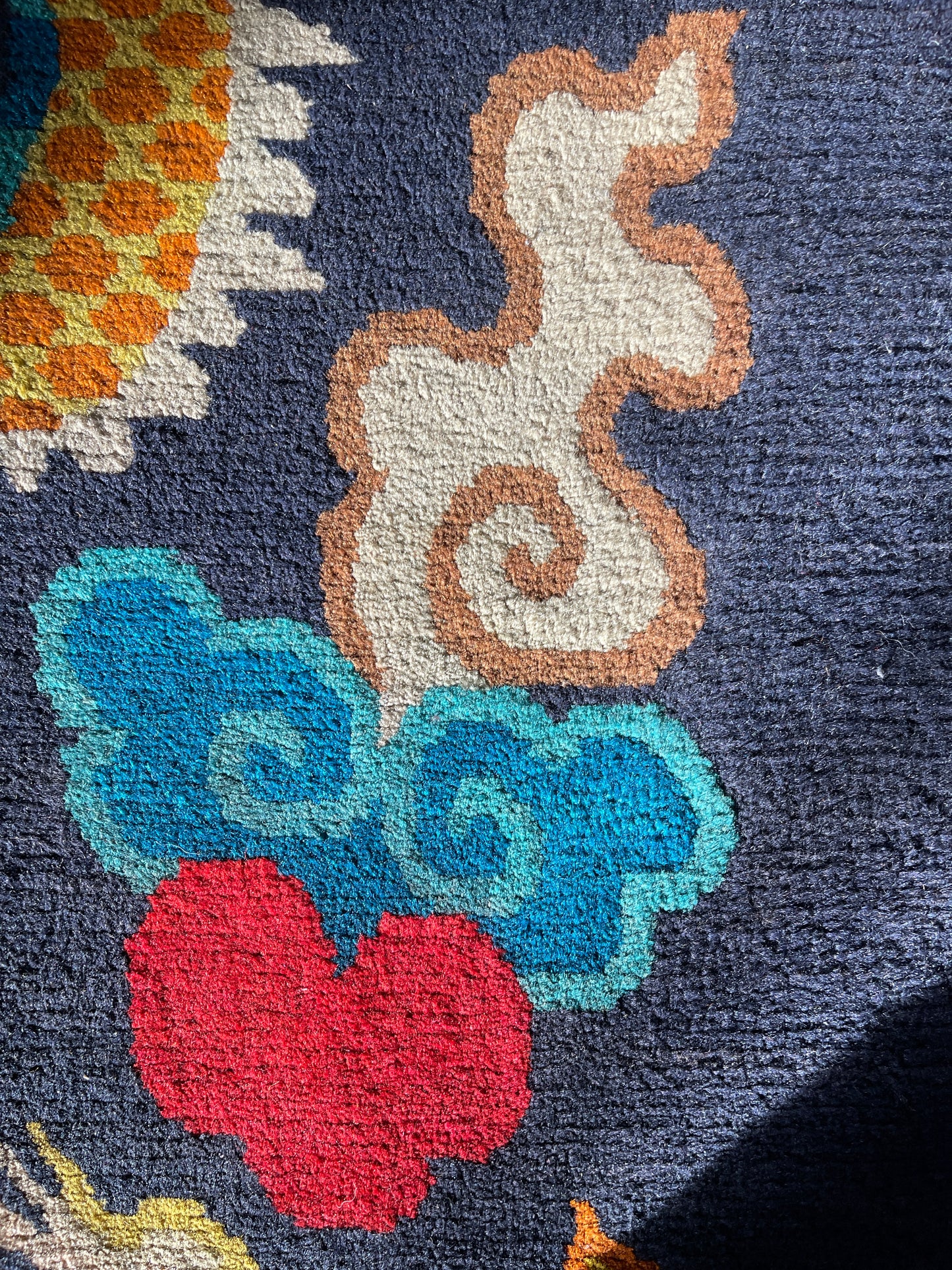 A vintage Tibetan rug featuring a dragon and phoenix