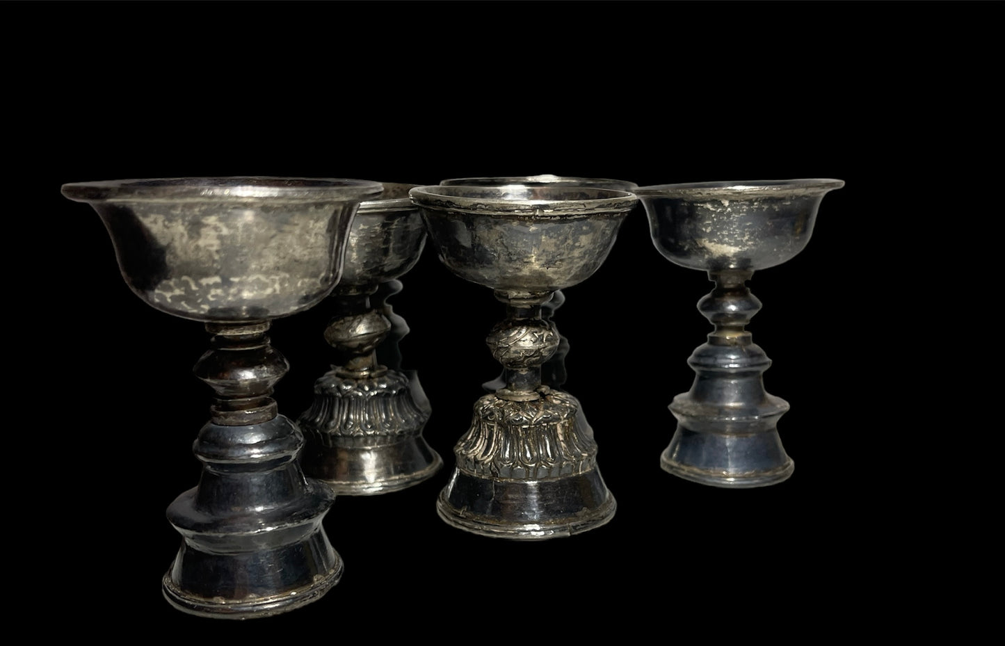 A set of 6 antique Tibetan silver butter lamps