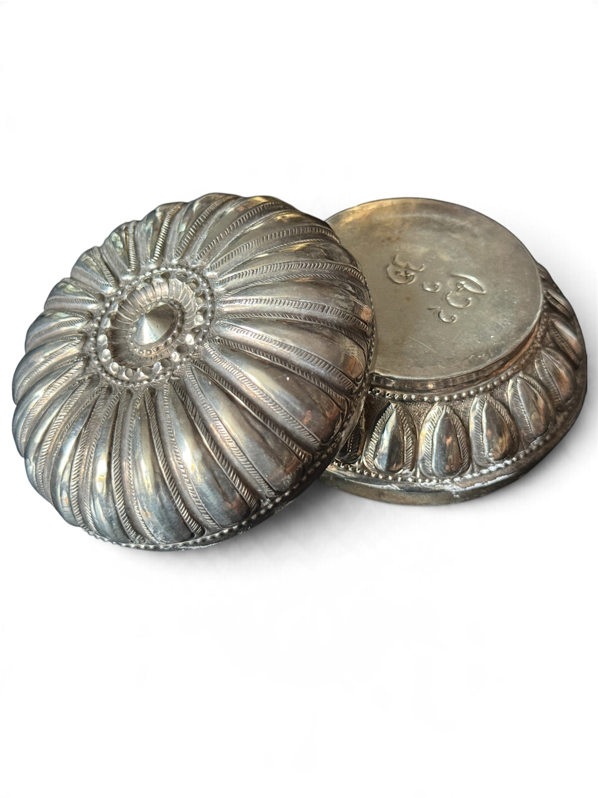 An antique silver south East Asian round box with lid