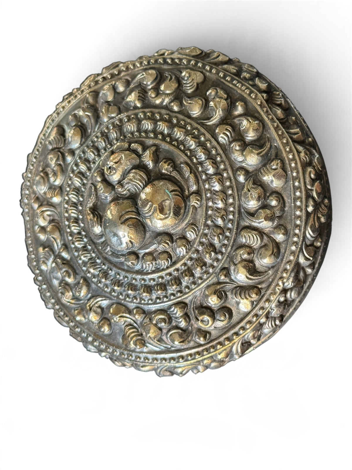 An antique silver south East Asian round box with lid