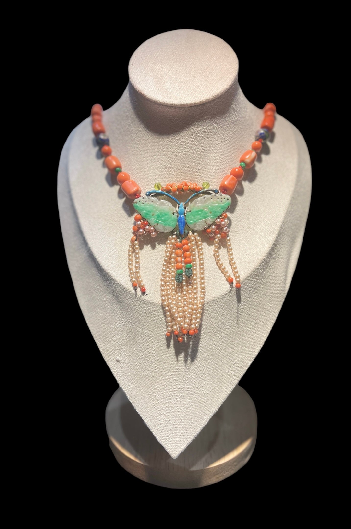A jade butterfly pendant necklace with coral bead necklace