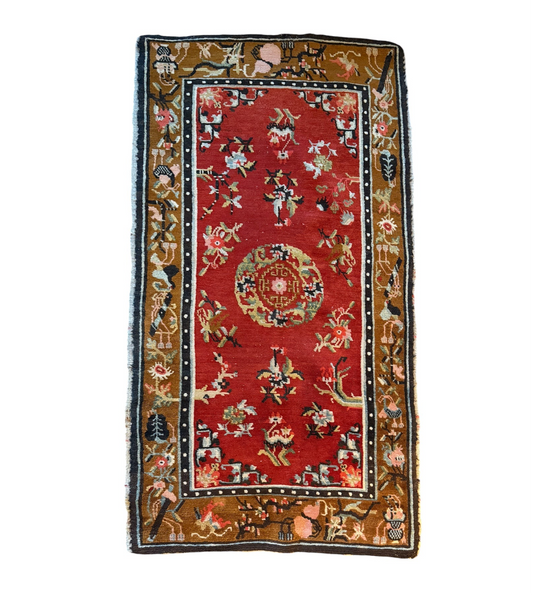 An antique Tibetan wool rug