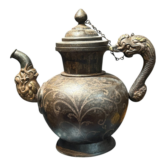 An antique Tibetan iron and silver teapot