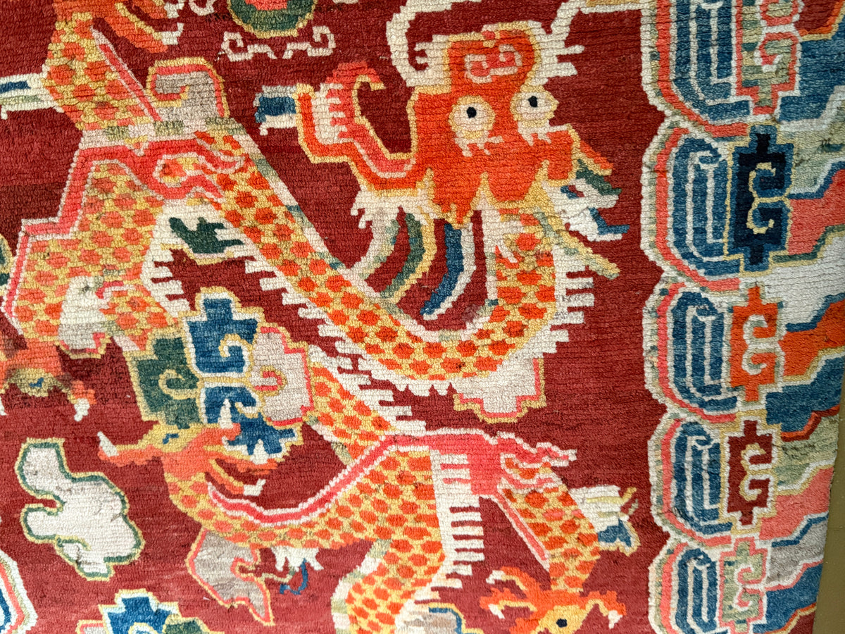 An early 20th C., antique Tibetan dragon rug