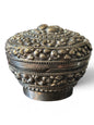 An antique silver south East Asian round box with lid