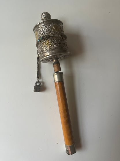 An antique Tibetan handheld prayer wheel