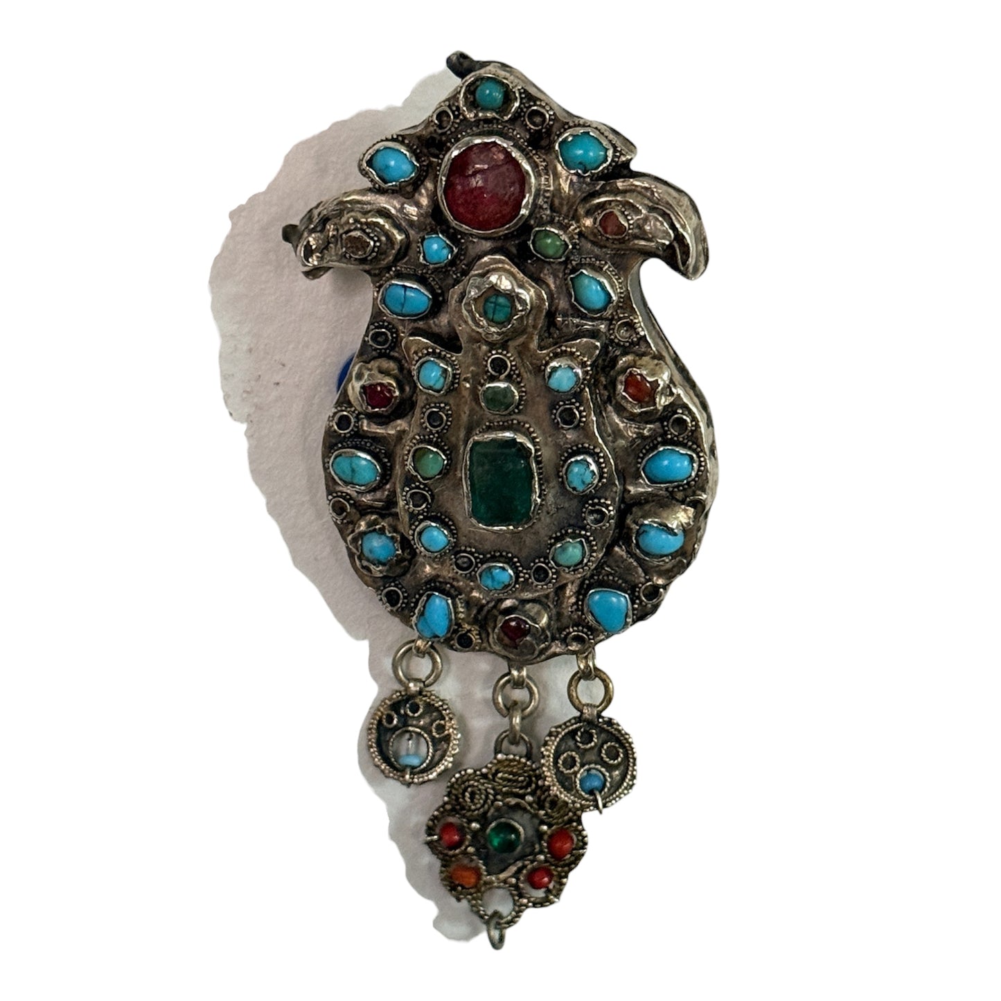A silver antique turban brooch with turquoise, ruby and emeralds