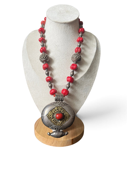 Antique Tibetan coral ghau pendant with a coral and silver necklace