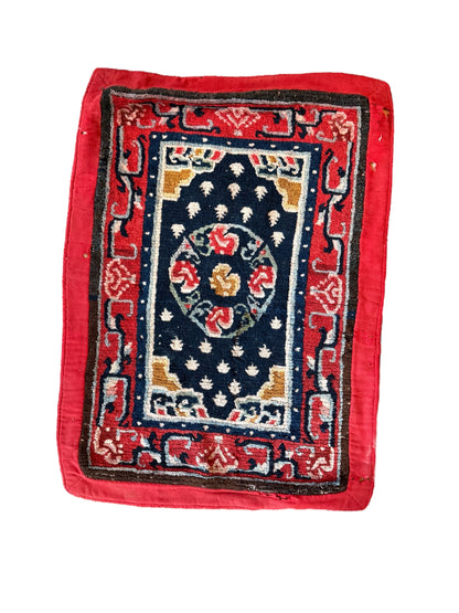 An antique Tibetan saddle rug and rug topper set