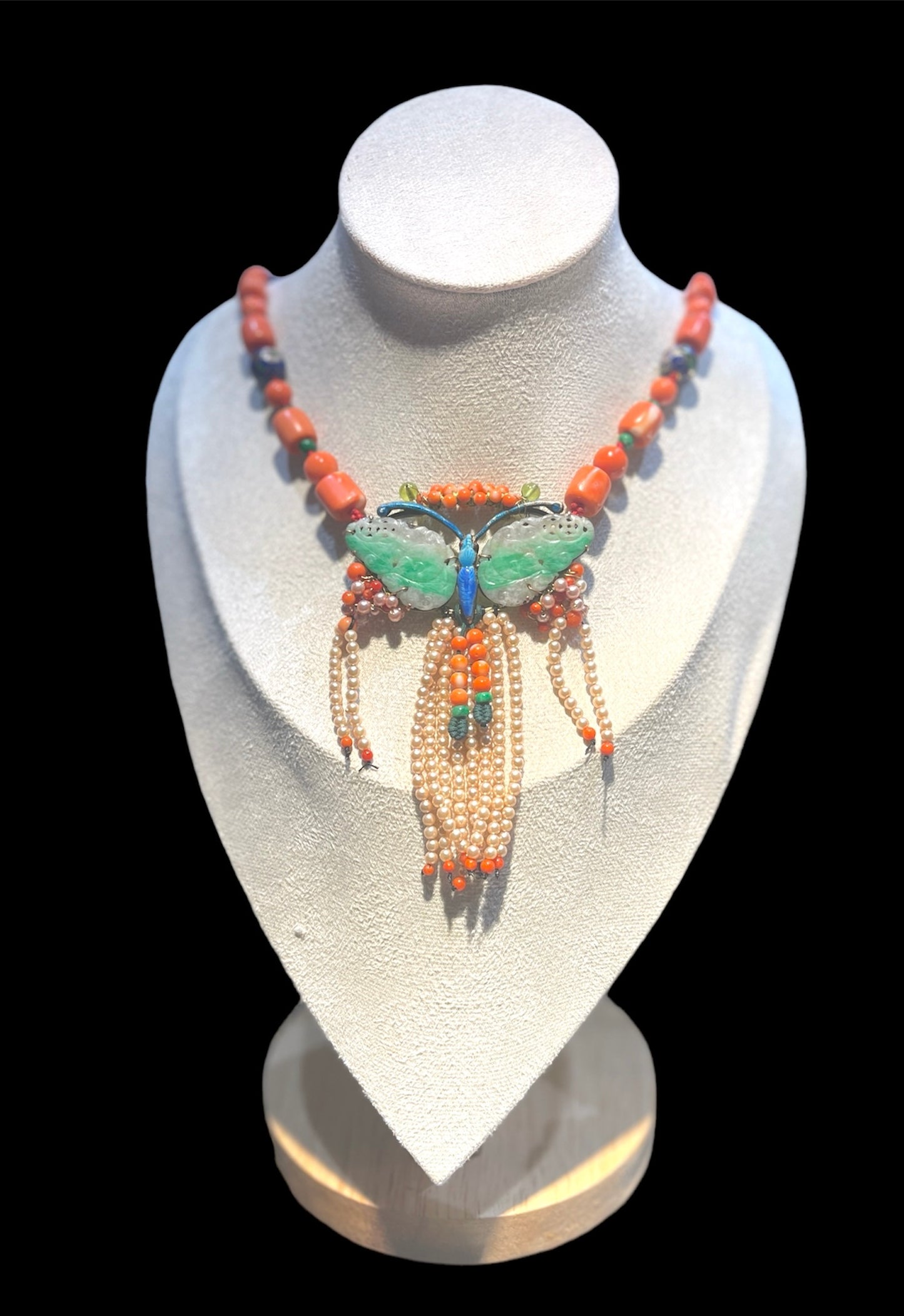 A jade butterfly pendant necklace with coral bead necklace
