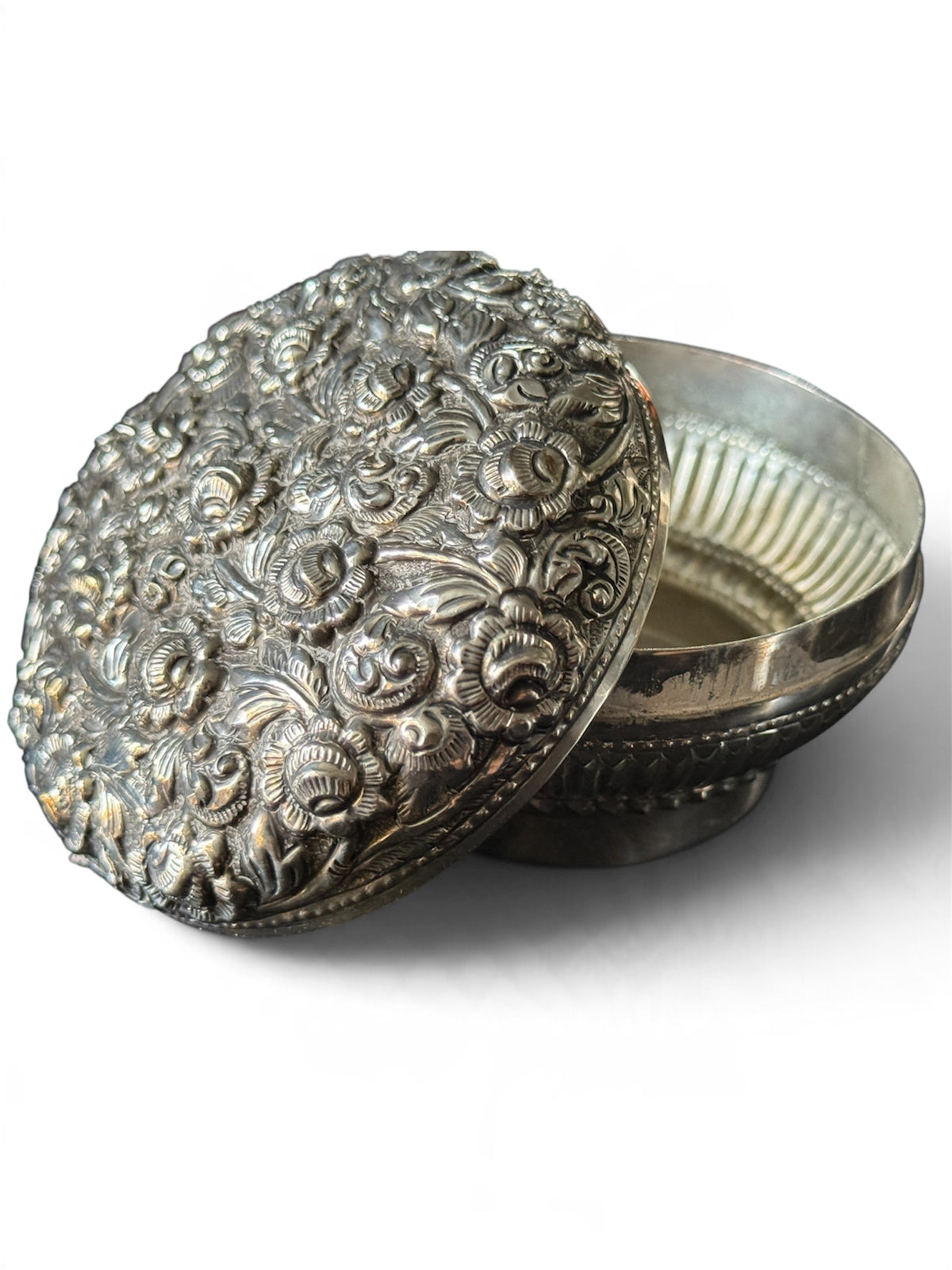 An antique silver south East Asian round box with lid
