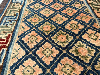 Antique rug with floral motifs arranged in a geometrical design