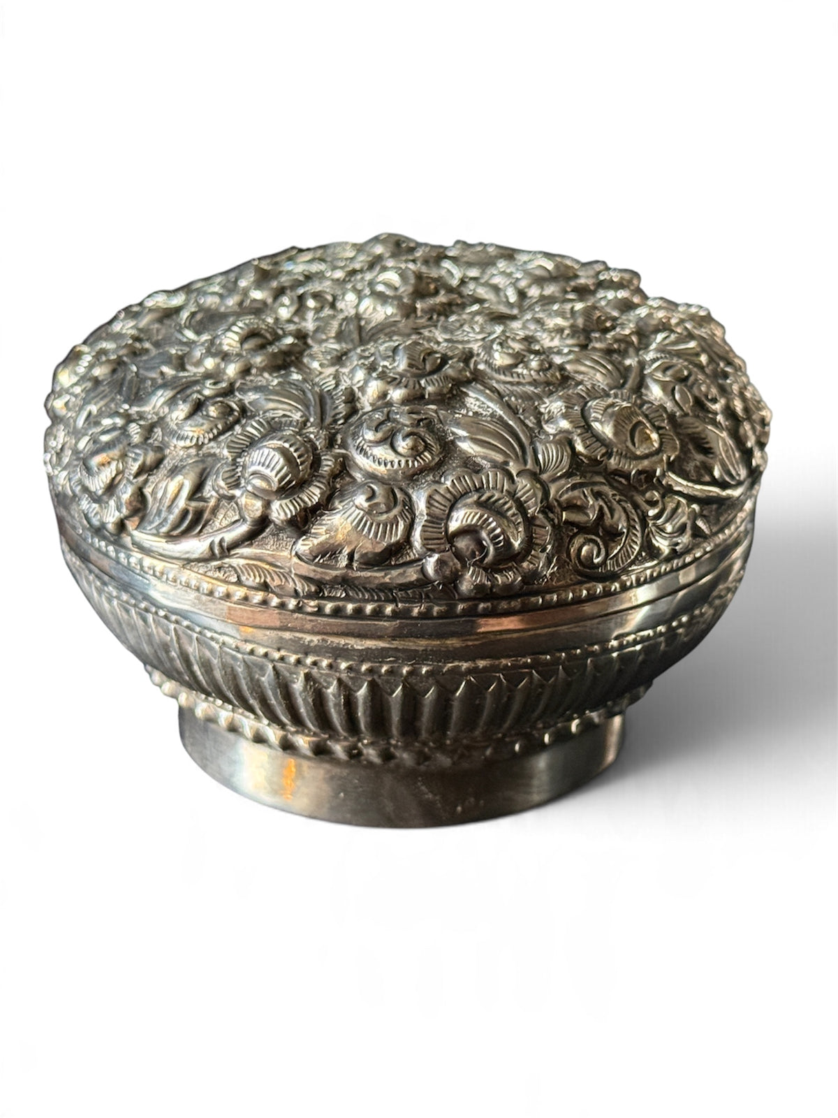 An antique silver south East Asian round box with lid