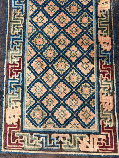 Antique rug with floral motifs arranged in a geometrical design