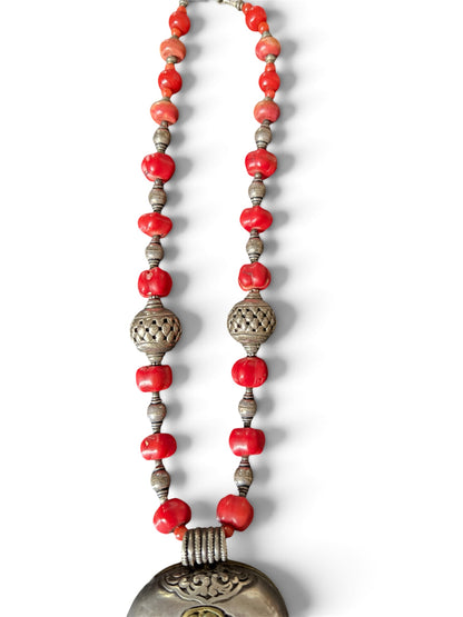 Antique Tibetan coral ghau pendant with a coral and silver necklace