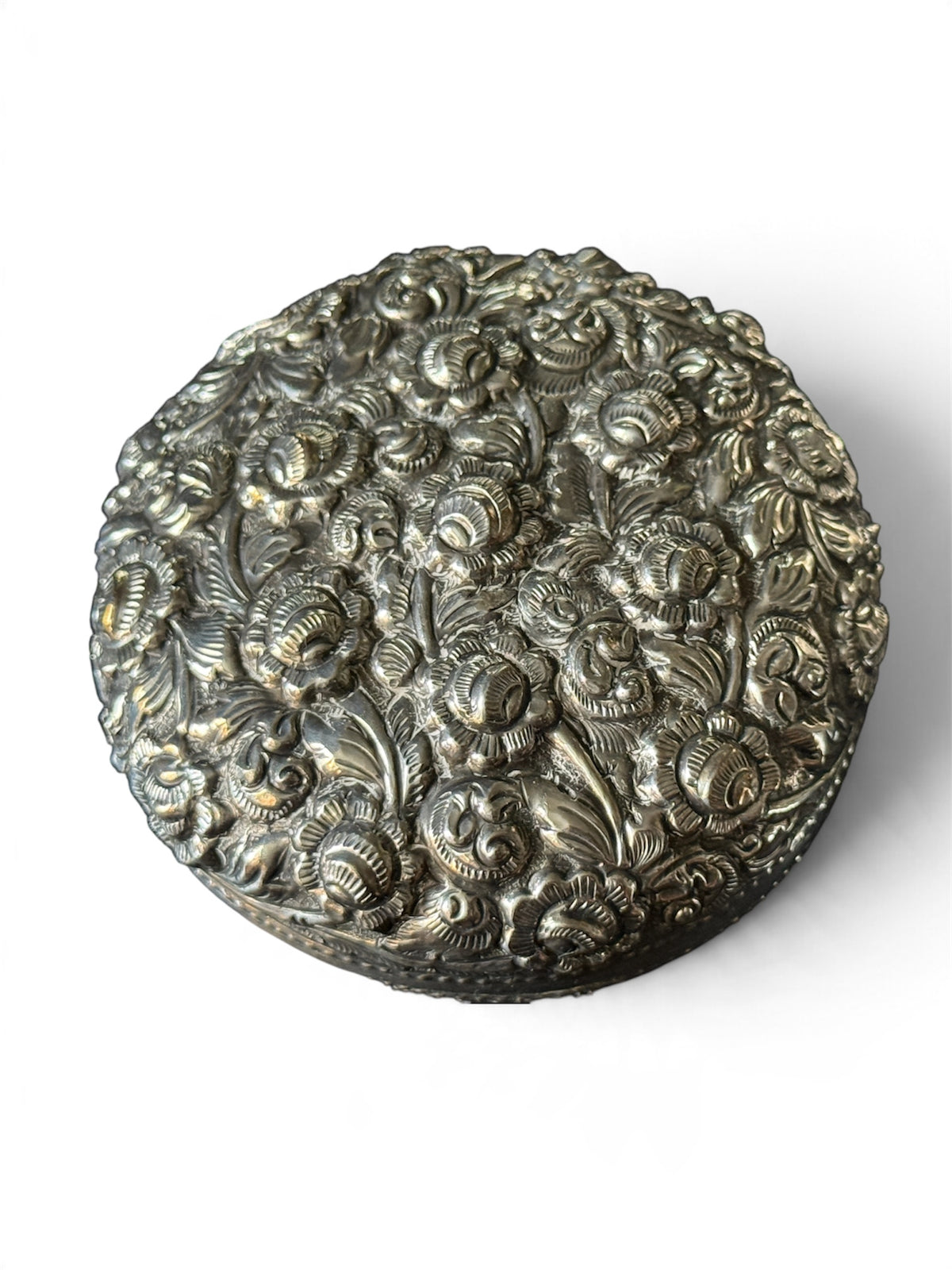 An antique silver south East Asian round box with lid