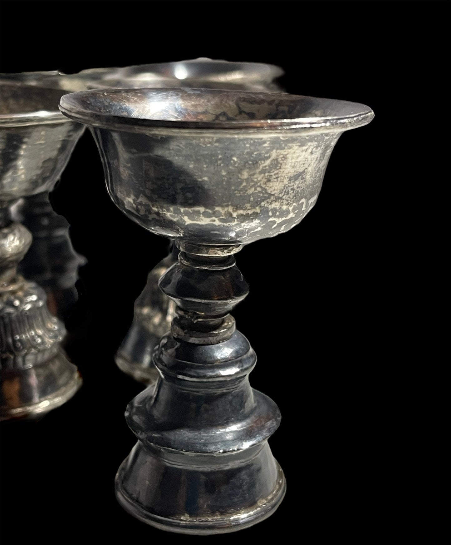 A set of 6 antique Tibetan silver butter lamps