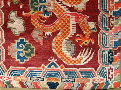 An early 20th C., antique Tibetan dragon rug