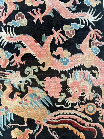 A mid 20th C., Tibetan dragon and phoenix rug