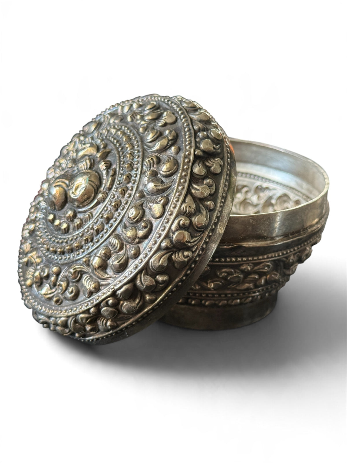An antique silver south East Asian round box with lid