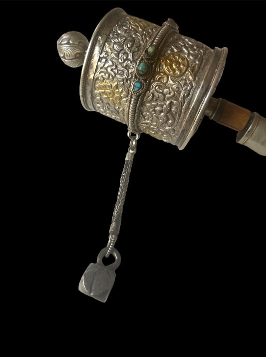 An antique Tibetan handheld prayer wheel