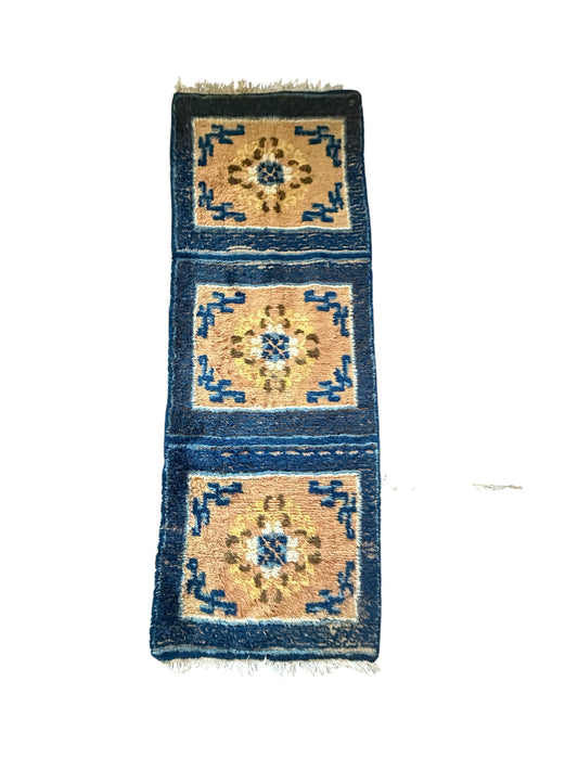An antique triple seater Tibetan meditation rug
