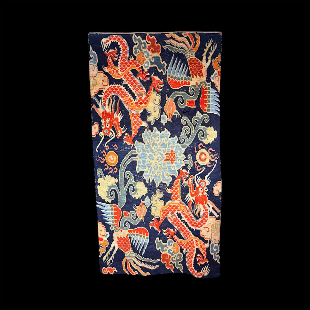 A mid 20th C., Tibetan dragon and phoenix rug