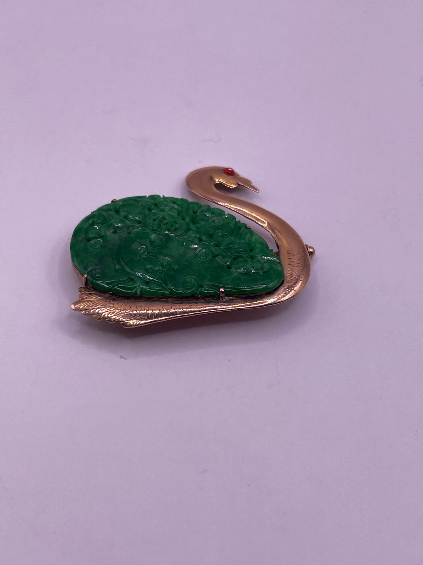A jade plaque pin in a gold setting