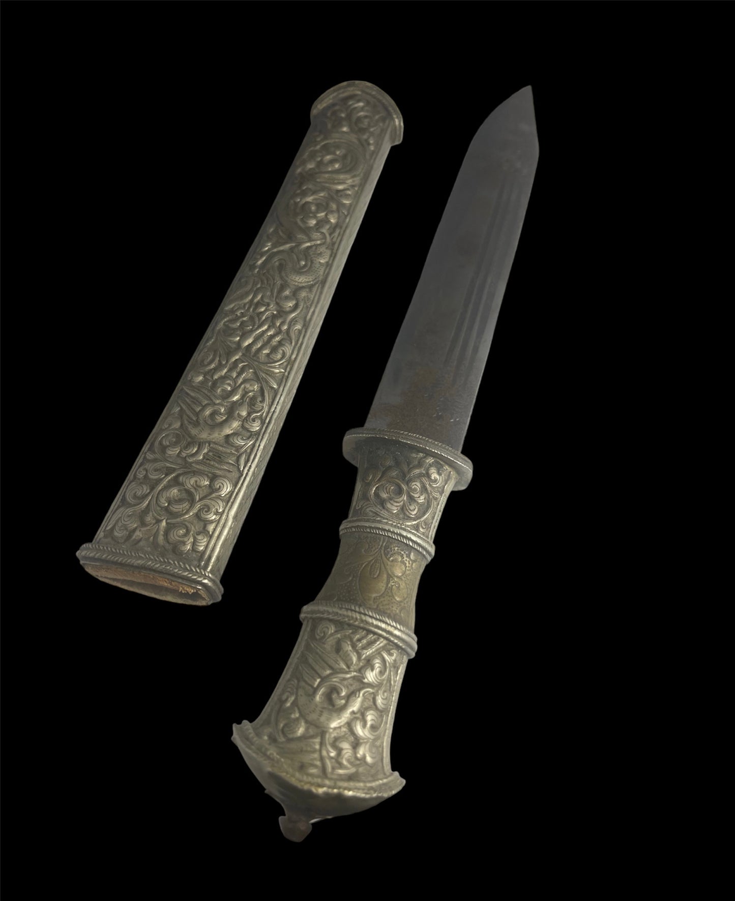 An antique Tibetan dagger with a carved sheath