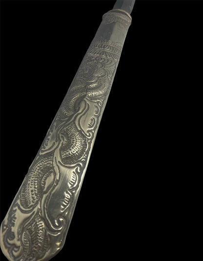 An antique Tibetan dagger with a carved silver sheath