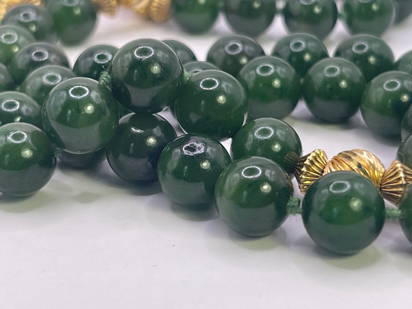 A jade nephrite and gold bead necklace