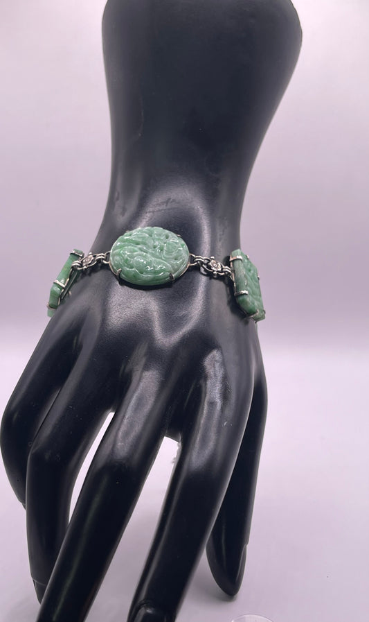 A silver bracelet with jade plaques