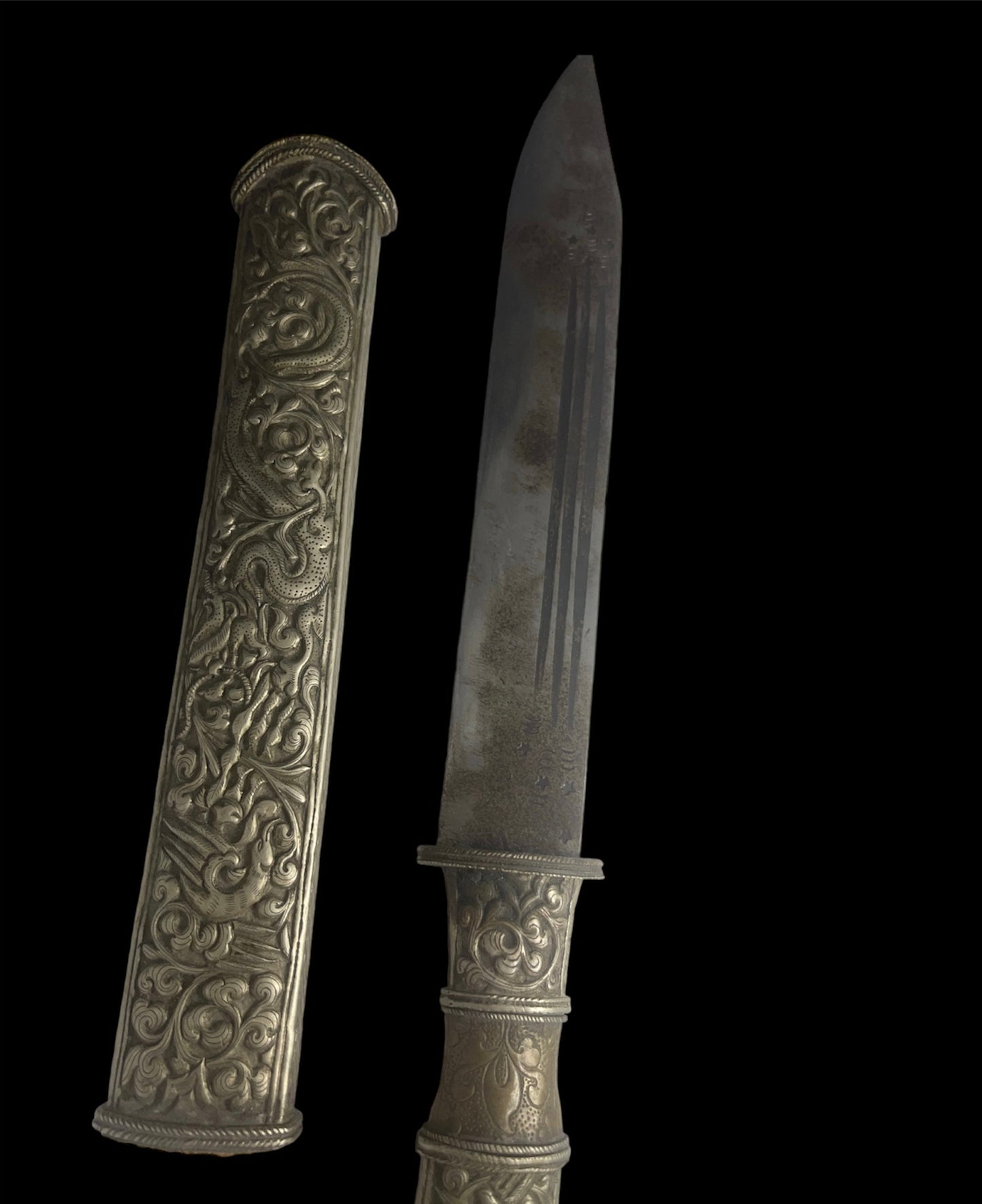 An antique Tibetan dagger with a carved sheath