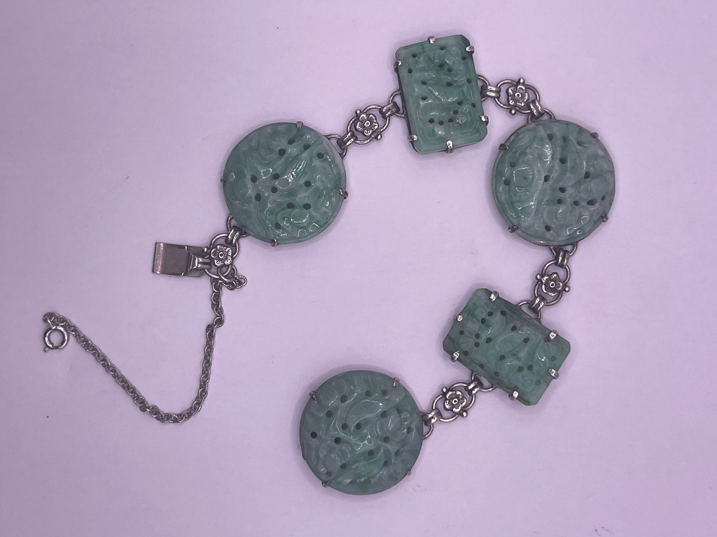 A silver bracelet with jade plaques